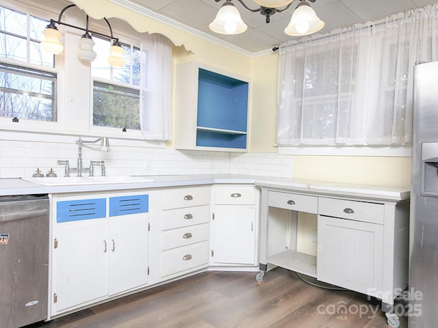 kitchen with white cabinetry, sink, hanging light fixtures, stainless steel appliances, and dark wood-type flooring