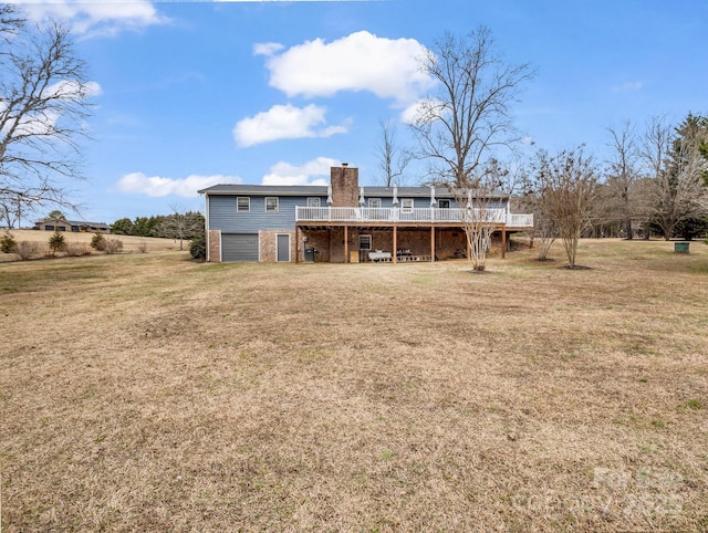 rear view of house featuring a deck and a lawn