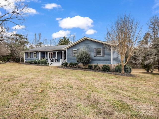 ranch-style home with covered porch and a front yard