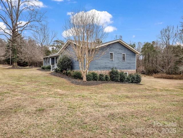 view of side of home featuring a lawn