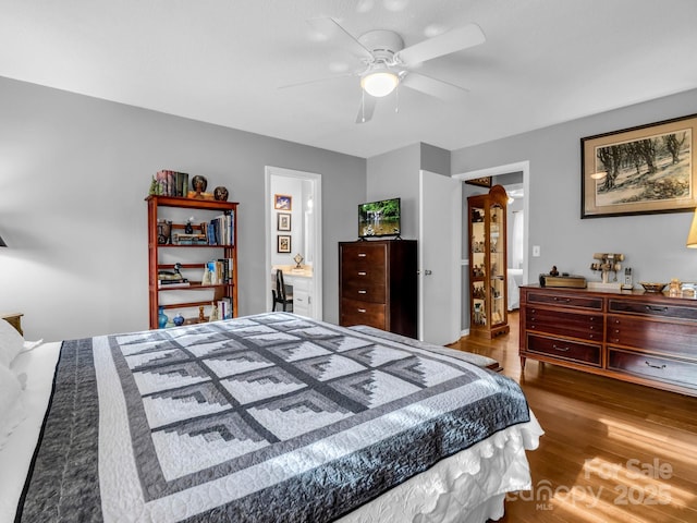 bedroom with connected bathroom, wood-type flooring, and ceiling fan