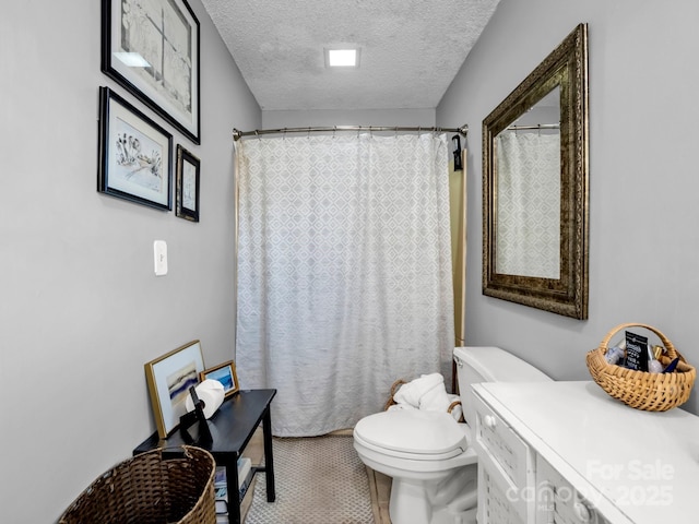 bathroom with walk in shower, tile patterned floors, toilet, and a textured ceiling