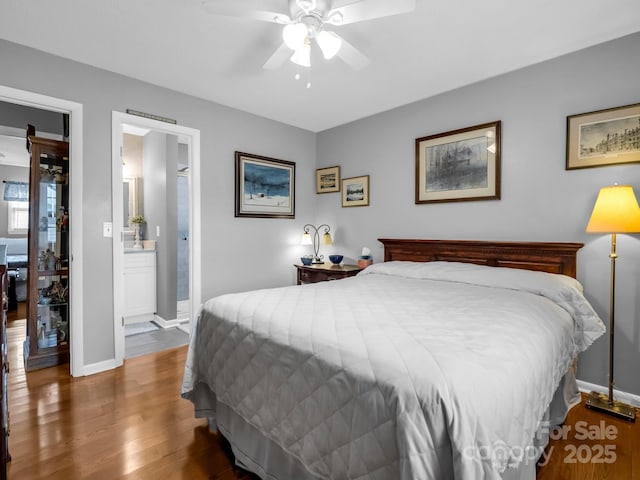 bedroom featuring dark hardwood / wood-style flooring, connected bathroom, and ceiling fan