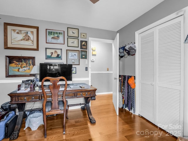 home office with wood-type flooring