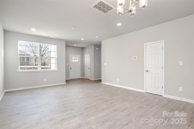 interior space featuring a notable chandelier and light wood-type flooring