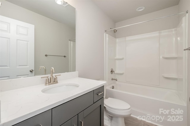 full bathroom featuring vanity, tub / shower combination, and toilet