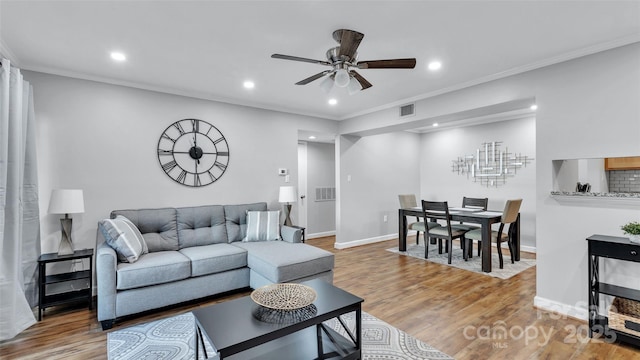 living room with ceiling fan, wood-type flooring, and crown molding