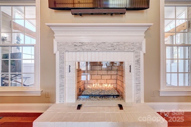 interior details featuring a wall mounted AC and a brick fireplace