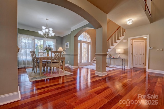 unfurnished dining area with crown molding, wood-type flooring, and a chandelier