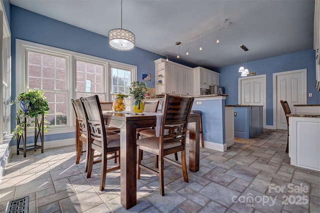 dining space featuring track lighting