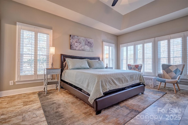 bedroom featuring a tray ceiling and ceiling fan