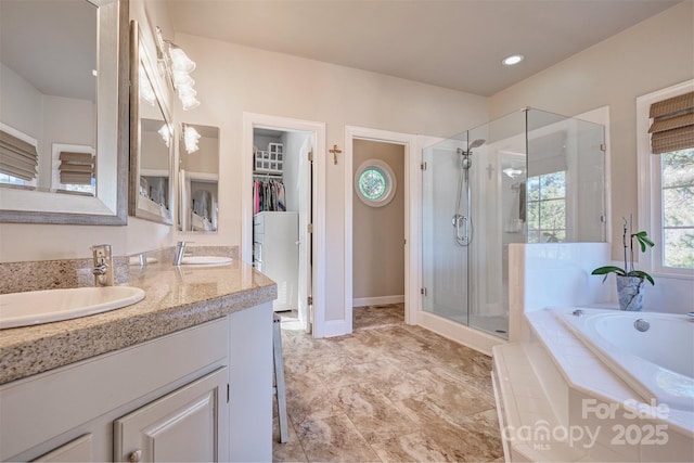 bathroom featuring shower with separate bathtub and vanity