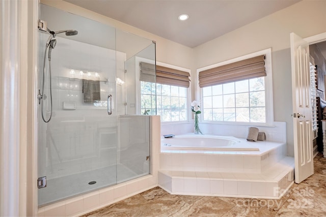 bathroom featuring a wealth of natural light and plus walk in shower