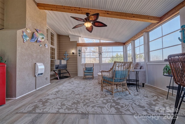 sunroom featuring vaulted ceiling with beams and ceiling fan