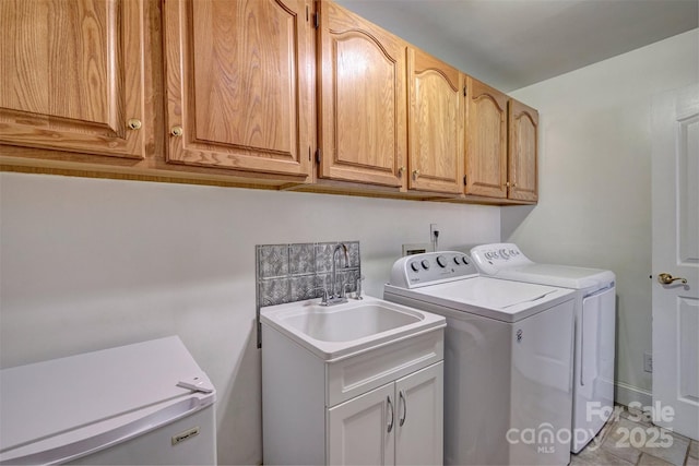 laundry room with separate washer and dryer, sink, cabinets, and light tile patterned flooring