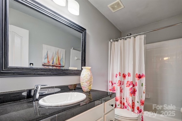 full bathroom featuring vanity, toilet, and shower / tub combo