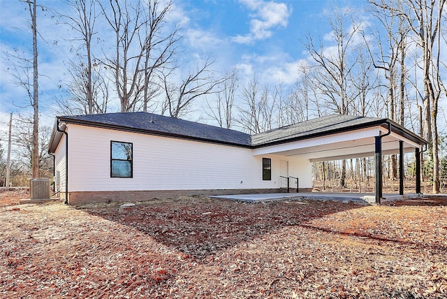 view of property exterior featuring central AC unit and a carport