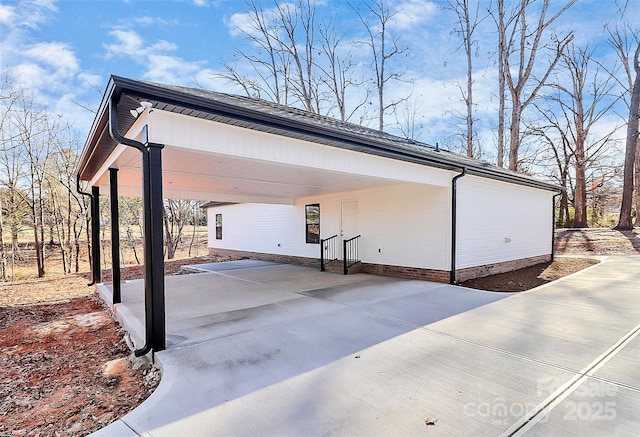 view of side of home with a carport