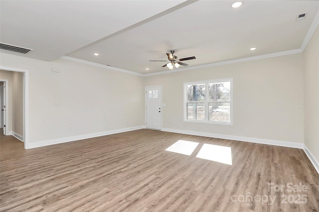 empty room with ceiling fan, ornamental molding, and light hardwood / wood-style floors