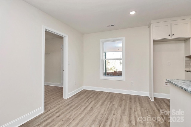 unfurnished dining area with light hardwood / wood-style flooring