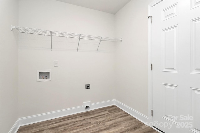 clothes washing area with hardwood / wood-style flooring, hookup for a washing machine, and electric dryer hookup