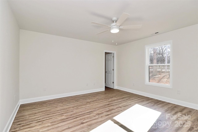 spare room with ceiling fan and light hardwood / wood-style flooring