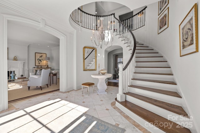 foyer with a chandelier and ornamental molding