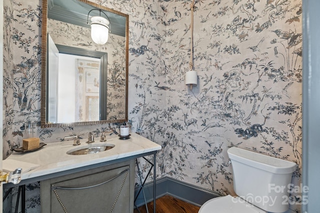 bathroom featuring hardwood / wood-style floors, toilet, and vanity