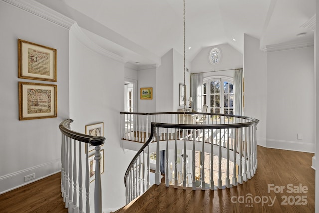 corridor featuring dark hardwood / wood-style flooring, crown molding, and vaulted ceiling