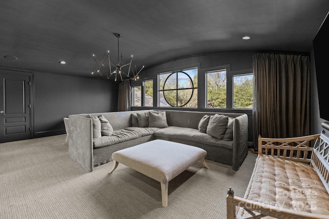 carpeted living room with lofted ceiling and a chandelier