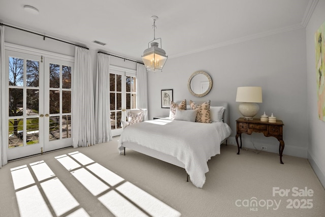 bedroom featuring light colored carpet, multiple windows, crown molding, and french doors