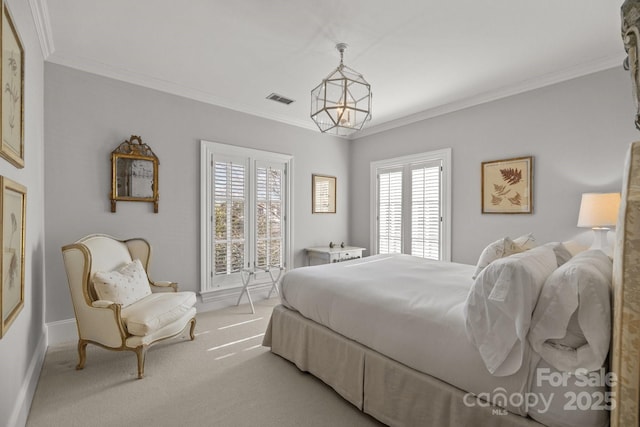 carpeted bedroom featuring crown molding and an inviting chandelier