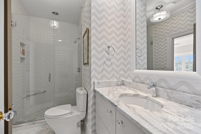 bathroom with vanity, a shower with shower door, and toilet