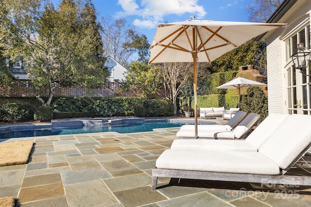 view of pool featuring an in ground hot tub, a patio, and outdoor lounge area