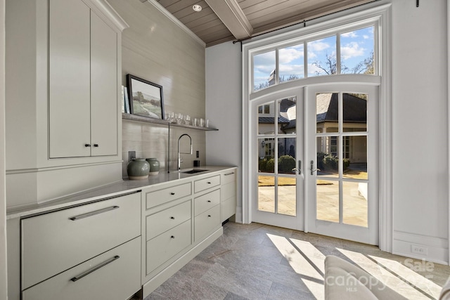 interior space featuring sink, french doors, beamed ceiling, and wood ceiling