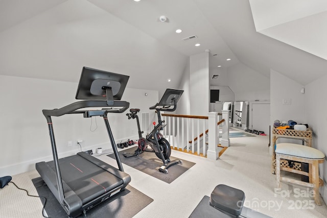 exercise area with vaulted ceiling and carpet