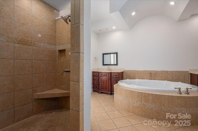 bathroom featuring tile patterned flooring, vanity, and separate shower and tub