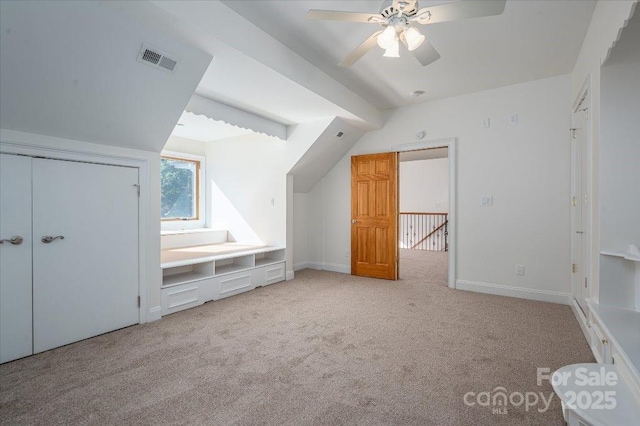 bonus room with ceiling fan, lofted ceiling, and light carpet