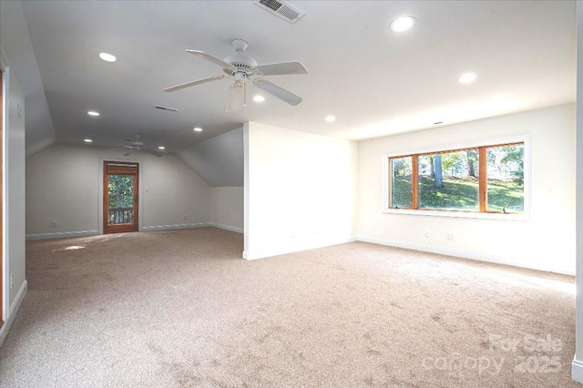 additional living space with lofted ceiling, ceiling fan, and carpet flooring