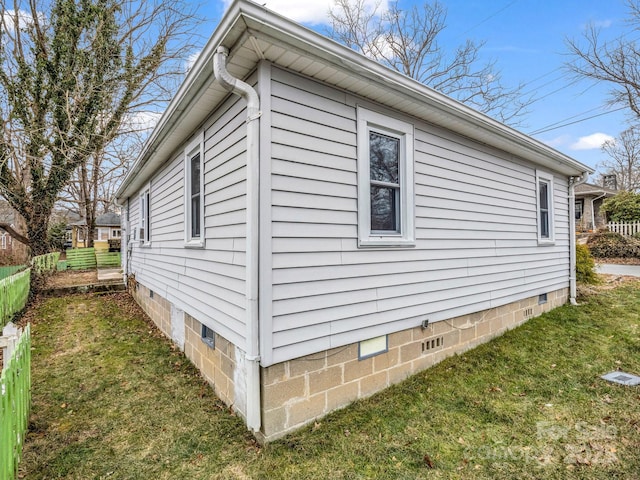 view of side of property with a yard