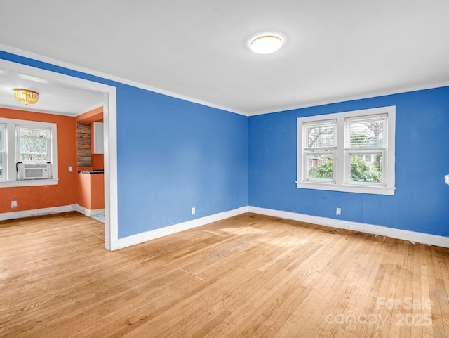 empty room featuring cooling unit and light hardwood / wood-style flooring