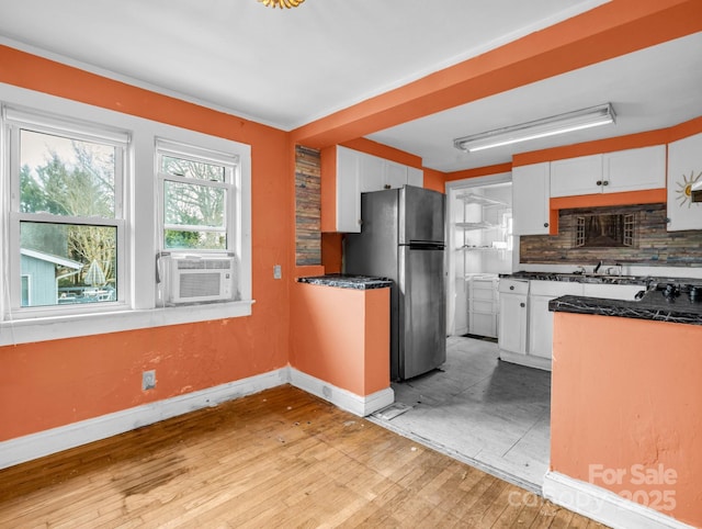 kitchen featuring white cabinetry, backsplash, cooling unit, and stainless steel refrigerator