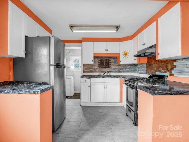 kitchen featuring stainless steel appliances, sink, white cabinets, and decorative backsplash