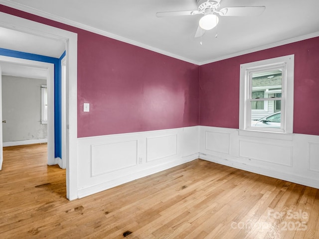 spare room with ceiling fan, wood-type flooring, and ornamental molding