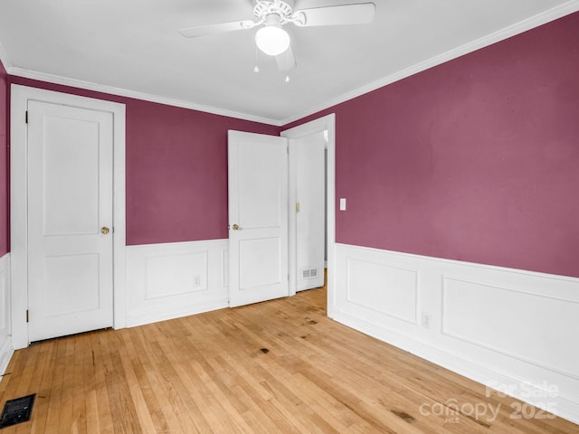 unfurnished bedroom featuring crown molding, ceiling fan, and light hardwood / wood-style floors