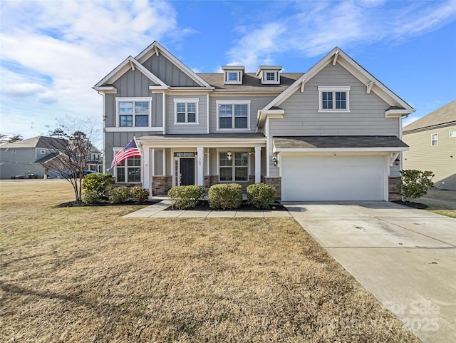 craftsman-style house featuring a garage, a front lawn, and a porch