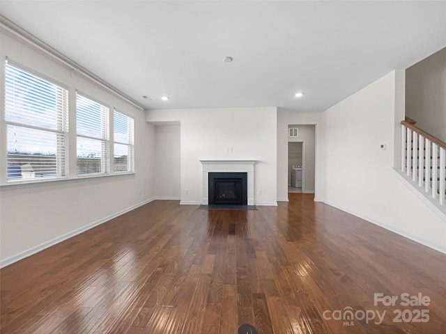 unfurnished living room featuring dark wood-type flooring