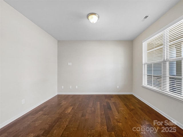 unfurnished room featuring dark hardwood / wood-style flooring