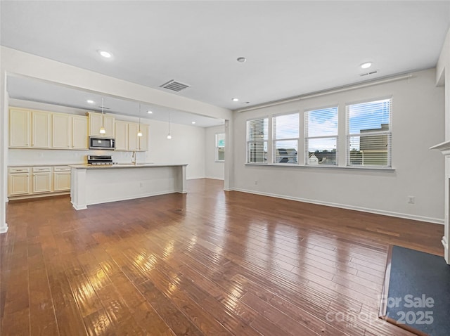 unfurnished living room featuring dark wood-type flooring and sink