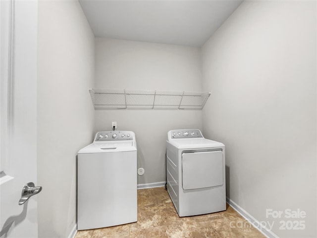 clothes washing area featuring separate washer and dryer